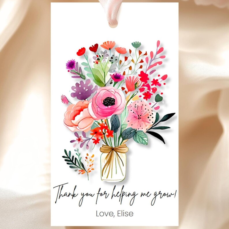 May include: A white card with a watercolor illustration of a bouquet of pink, red, and purple flowers in a mason jar. The text on the card reads "Thank you for helping me grow! Love, Elise."