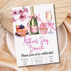 May include: A pink and white Mother's Day brunch invitation with a watercolor illustration of a cupcake, champagne flute, champagne bottle, and a plate of pancakes with blueberries and strawberries. The text reads "Mother's Day Brunch" and "Please join us to celebrate!" with details for the event including the date, time, and location.