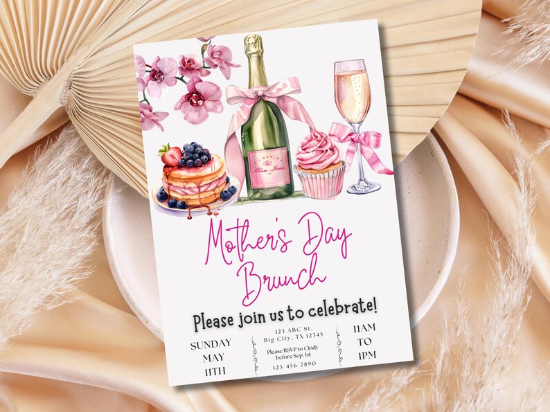 May include: A pink and white Mother's Day brunch invitation with a watercolor illustration of a cupcake, champagne flute, champagne bottle, and a plate of pancakes with blueberries and strawberries. The text reads "Mother's Day Brunch" and "Please join us to celebrate!" with details for the event including the date, time, and location.