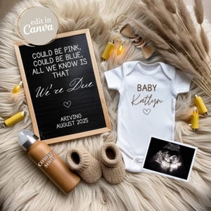 May include: A black letter board with the text "COULD BE PINK, COULD BE BLUE, ALL WE KNOW IS THAT We're Due ARRIVING AUGUST 2025". A white onesie with the text "BABY Kattyn" and a heart. A wooden baby bottle with the text "COMING SOON". A pair of beige knitted baby booties. A black and white ultrasound image.