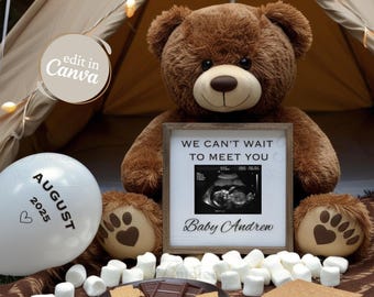May include: A brown teddy bear holding a framed ultrasound image with the text "We can't wait to meet you Baby Andrew". A white balloon with the text "August 2025" and a heart is in the foreground. There are also graham crackers, chocolate squares, and marshmallows on a brown and white patterned surface.