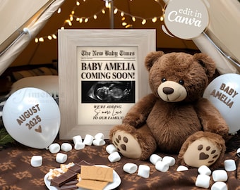 May include: A framed newspaper announcement with the text "The New Baby Times" and "Baby Amelia Coming Soon!" with a sonogram image. A brown teddy bear sits next to the frame with two white balloons that say "August 2025" and "Baby Amelia".