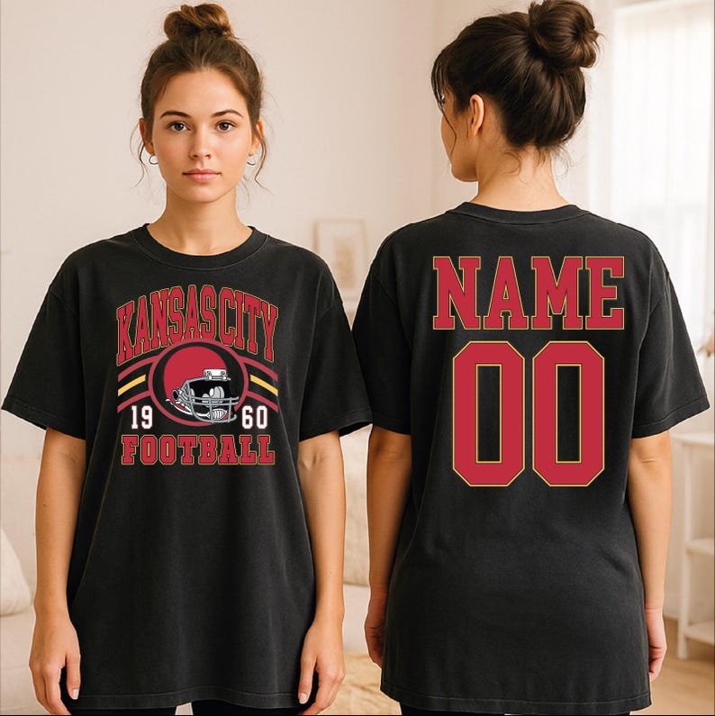 A woman wearing a black t-shirt with a graphic design and text printed on it.