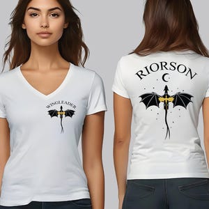 A woman wearing a white t-shirt with a dragon design and the text "Riorson" printed on the back.