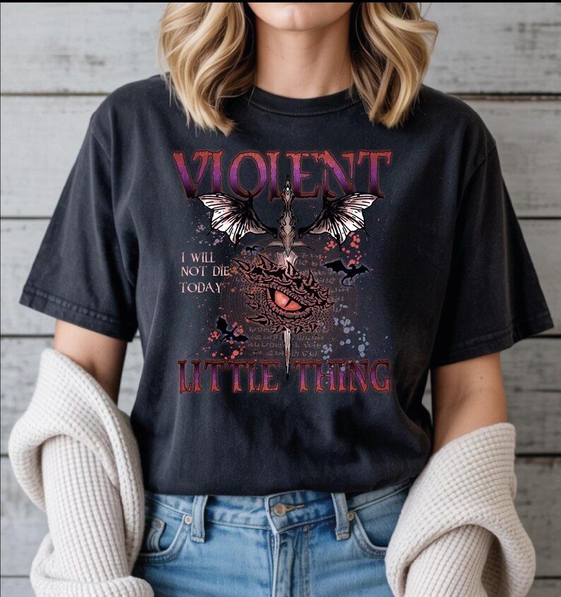 A person wearing a black t-shirt with a graphic design featuring a dragon, text, and a quote.