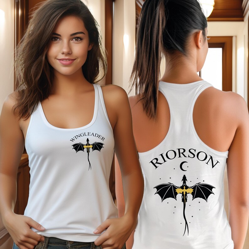 A woman wearing a white tank top with a dragon design and the text "WINGLEADERRIOR C" printed on it.