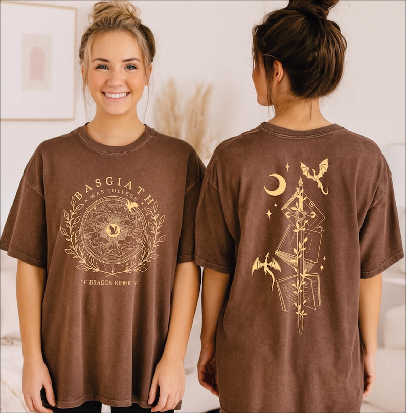 Two women wearing brown t-shirts with a graphic design on the front and back.