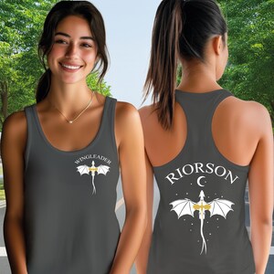 A woman wearing a gray tank top with a dragon design and the text "WISCLEADERRION C" printed on the back.