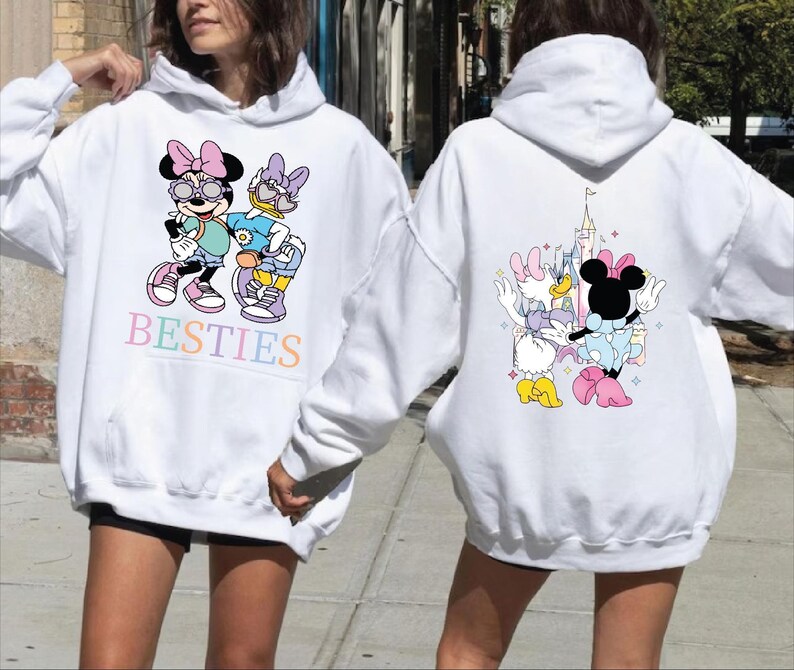 A woman wearing a white hoodie with a cartoon character design on the front and back.