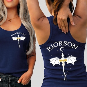 A woman wearing a navy blue tank top with a dragon design and the text "VINGLEADER" printed on it.