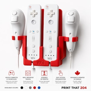 May include: A red wall-mounted plastic storage rack designed to hold two white Wii remotes and two white Nunchuk controllers. The rack features the Wii logo embossed on the front and includes text detailing its features and origin in Canada.