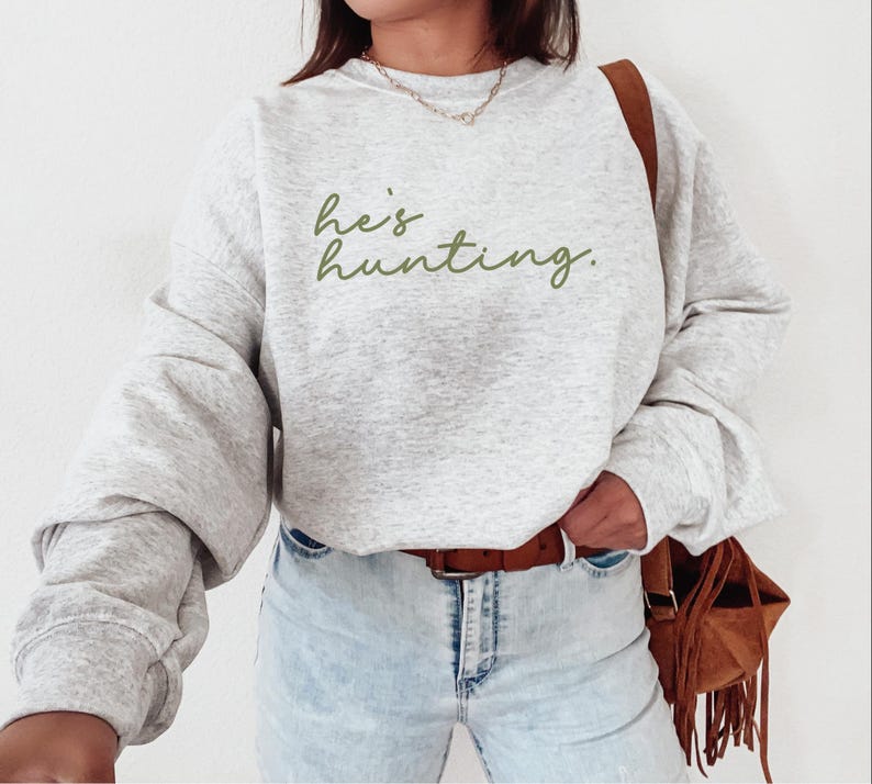 a woman wearing a sweatshirt that says, let's hunting