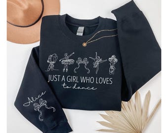 May include: Black sweatshirt with a white design of ballerinas and the text "Just a girl who loves to dance". The word "Alice" is written on the sleeve.