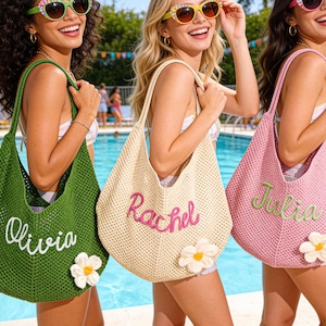 May include: Three women holding personalized crochet tote bags by a pool. The bags are in green, beige, and pink, each with a name embroidered in a contrasting color. Each bag has a white flower accent.