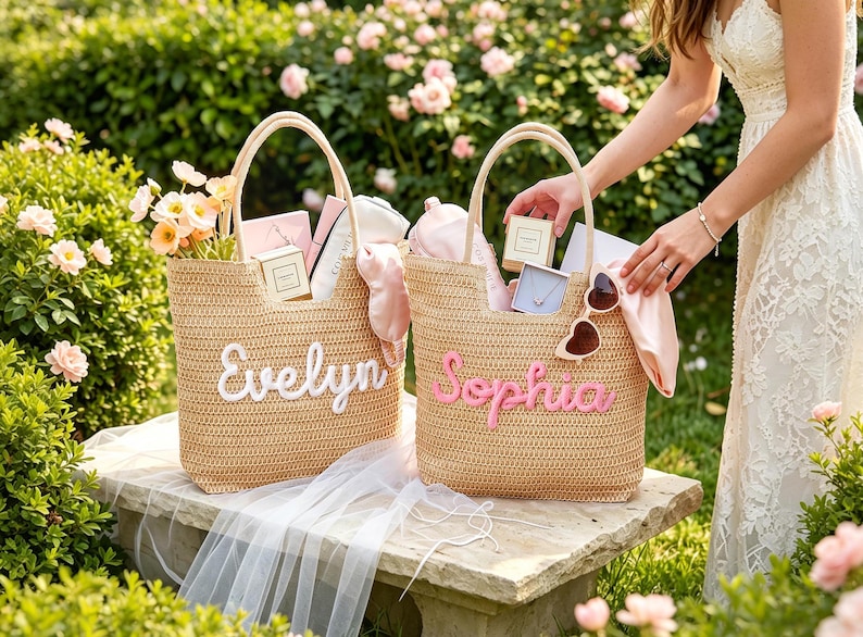 May include: Two woven straw tote bags featuring personalized names in script lettering. One bag displays the name Evelyn in white, while the other displays the name Sophia in pink. Both bags are filled with various small gift items and accessories.