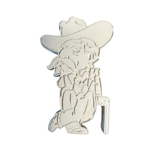 May include: A light-colored, three-dimensional figurine of a cartoon cowboy with a large hat, mustache, and cane. The cowboy is seated, with his legs crossed and his cane resting on the ground. The figurine is made of a solid, light-colored material.