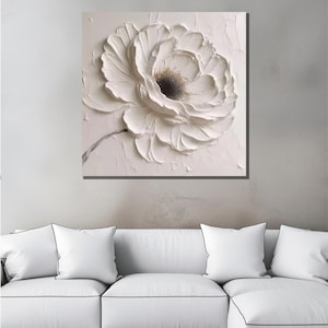 May include: White textured canvas painting of a large white flower with a dark center.