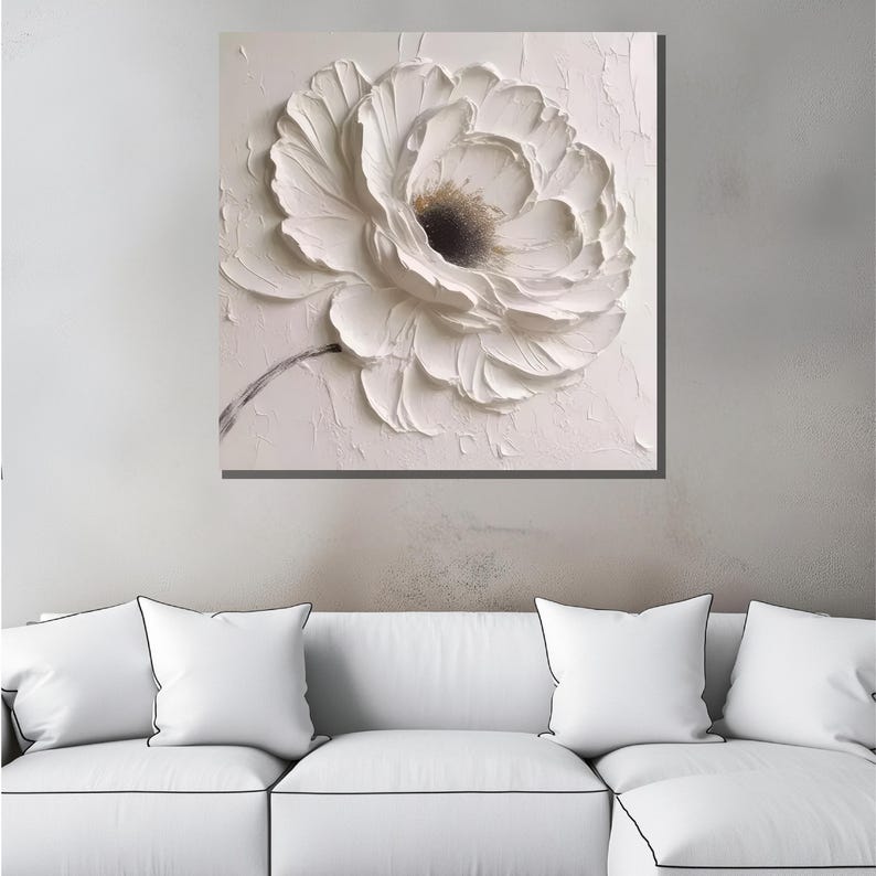 May include: White textured canvas painting of a large white flower with a dark center.