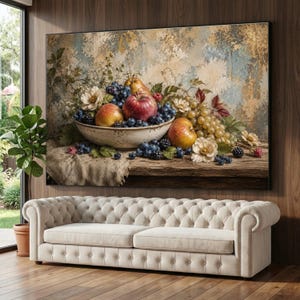 May include: A large rectangular wall art print featuring a still life painting of a ceramic bowl filled with red apples, green grapes, and dark blueberries. The bowl sits on a rustic wooden table draped with a textured cloth against a weathered wall.