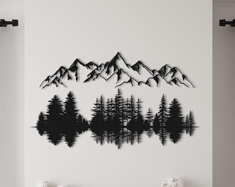 May include: Black metal wall art depicting a mountain range with trees reflected in a lake. The art is displayed above a fireplace in a living room with two wicker chairs and a coffee table.