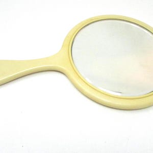 Vintage Round Celluloid Hand Mirror with Beveled Glass – 1930s Vanity Mirror with Wall Hanger – Shabby Chic Farmhouse Decor, 11.5 x 7 inches