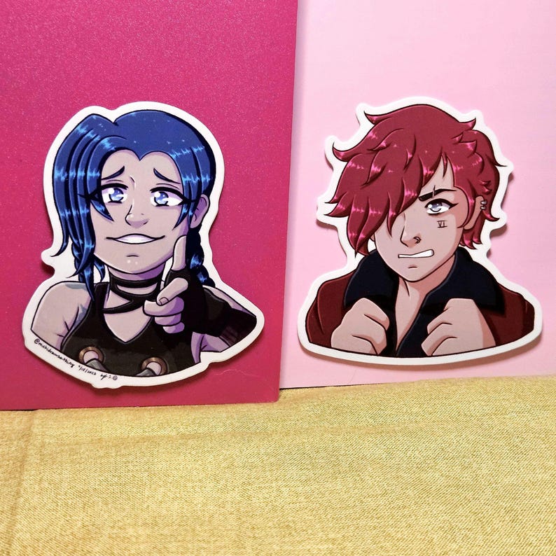 May include: Two die-cut stickers featuring anime-style characters. One sticker shows a character with blue hair, a black choker, and a pointing gesture. The other sticker depicts a character with red hair and a determined expression.