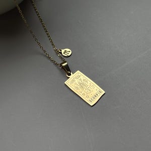 May include: Gold necklace with a pendant featuring a zodiac symbol and the word "SCORPIO".