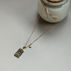 May include: Gold necklace with a Pisces zodiac sign pendant and a small star charm.