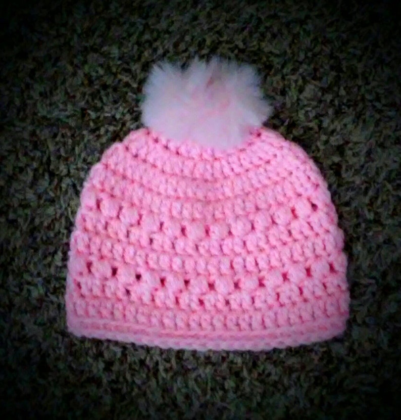 Crochet acrylic yarn hat with faux fur tassell