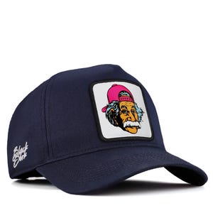 May include: A navy blue trucker hat with a white patch featuring a cartoon illustration of Albert Einstein wearing a pink baseball cap. The text "Black Bart" is embroidered on the front of the hat.