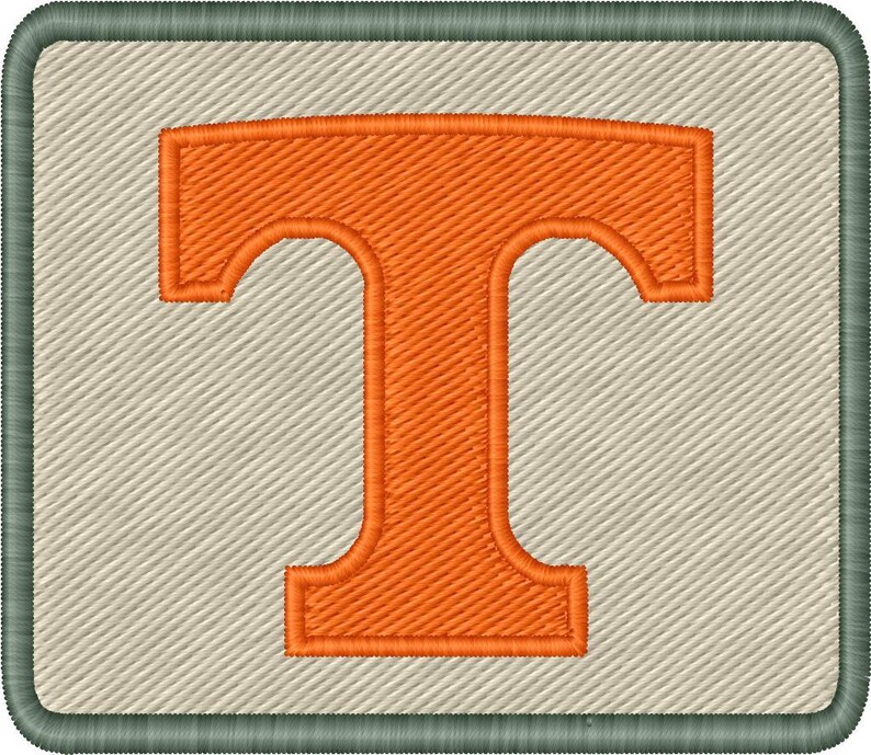 Op de afbeelding: Geborduurde patch met een grote oranje letter "T" op een lichtbeige achtergrond. De letter is gestikt met een textuurpatroon en de patch heeft een groene rand. Het ontwerp is rechthoekig.