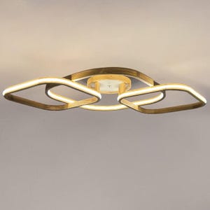 May include: A ceiling light fixture featuring a central circular wooden mount with three interconnected, rounded square frames. The frames have a light wood finish and integrated LED strips that emit a warm, bright white glow.
