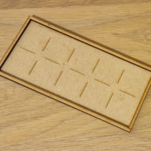 May include: A wooden tray with a grid pattern, perfect for organizing small items. The tray is made of natural wood and has a light brown color.