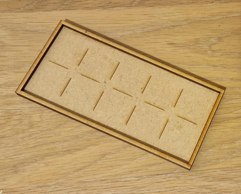 May include: A wooden tray with a grid pattern, perfect for organizing small items. The tray is made of natural wood and has a light brown color.
