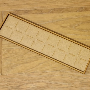 May include: A wooden tray with a grid of 16 squares. The tray is made of light brown wood and has a natural finish.