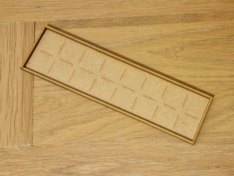May include: A wooden tray with a grid of 16 squares. The tray is made of light brown wood and has a natural finish.