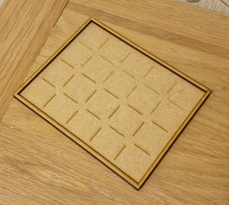 May include: A wooden tray with a grid pattern, perfect for organizing small items.
