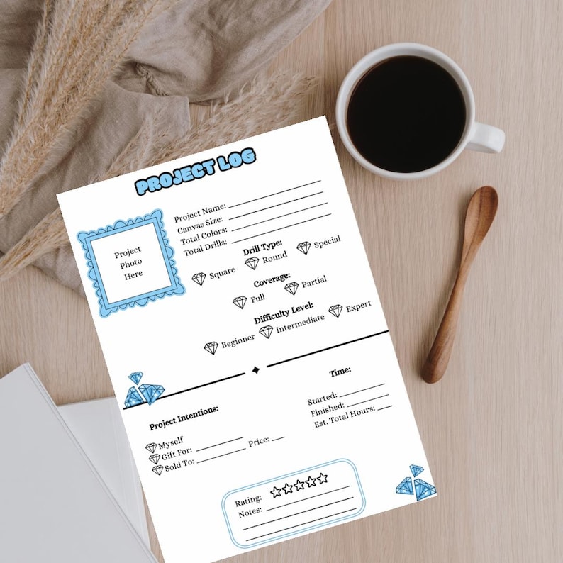 May include: A printable project log for diamond painting with sections for project details, intentions, time, rating, and notes. The log is decorated with blue diamond illustrations.