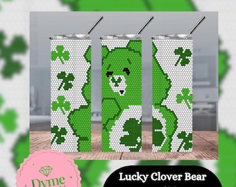 May include: A green and white tumbler with a clover and bear design. The tumbler is 20 ounces and is a skinny style. The text "Lucky Clover Bear 4mm/SS16 20oz Skinny Tumbler" is printed below the tumbler.