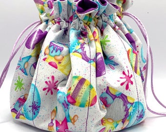 Tatting Bag #299.  Hoppy easter gnomies on white background. Kona Magenta (med purple)  lining.  Light purple drawstrings.