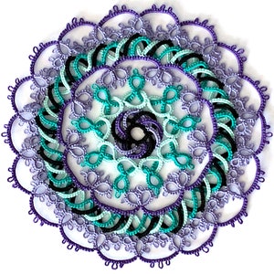 May include: A delicate crocheted doily with a circular design featuring multiple layers of intricate lacework in shades of purple, teal, and black.