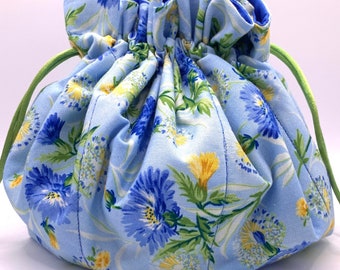 Tatting Bag #254. Blowing blooms on light blue background.  Bella Amelia Blue lining and yellow-green drawstrings.