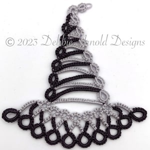 May include: A black and silver crocheted lace design in the shape of a witch's hat. © 2023 Debbie Arnold Designs