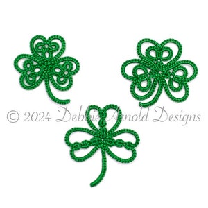 May include: Three green crocheted shamrock designs.  The shamrocks are intricate and detailed, with a delicate, lacy appearance.