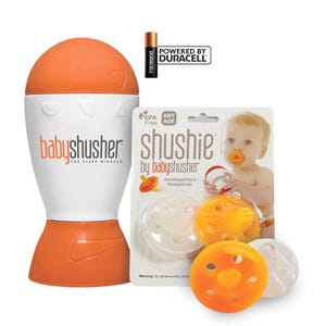 K&ouml;nnte beinhalten: Eine wei&szlig;e und orangefarbene Baby-Beruhigungshilfe mit einem Schnuller und dem Text "shushie by babyshusher" auf der Verpackung.