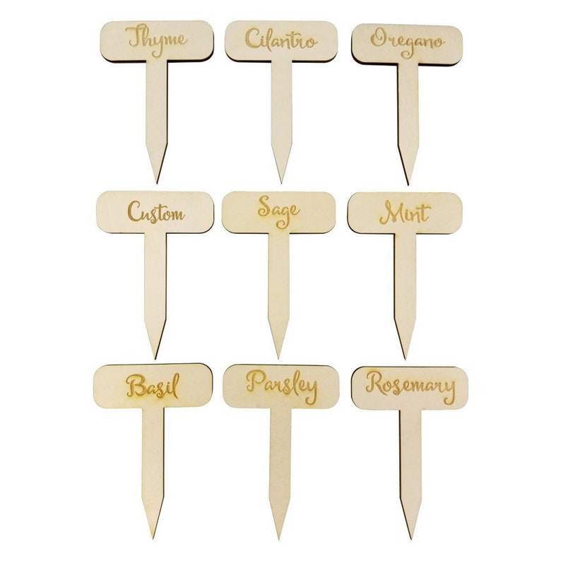 May include: Nine wooden plant markers with different herb names, including Thyme, Cilantro, Oregano, Custom, Sage, Mint, Basil, Parsley, and Rosemary. The markers are rectangular with rounded corners and have a wooden stake.
