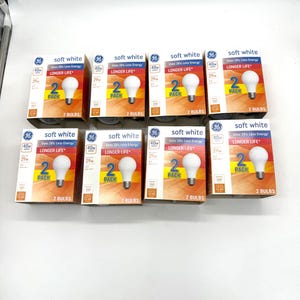 May include: Eight GE brand soft white light bulb boxes arranged in two rows. Each box features a 40W rating, a 2-pack label, and a graphic of a single light bulb. The packaging includes text stating Uses 28% Less Energy and Longer Life.
