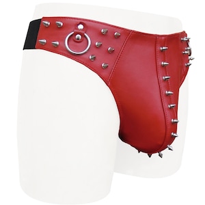 May include: Red leather garment with silver-colored metal studs and a ring detail. The garment has a black elastic band and is designed with a contoured shape. The studs are pointed and evenly spaced.
