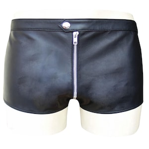 Może przedstawiać: Czarne skórzane szorty z srebrnym zamkiem błyskawicznym z przodu i zapięciem na zatrzask w pasie. Szorty są prezentowane na białym manekinie i mają klasyczny, minimalistyczny design.