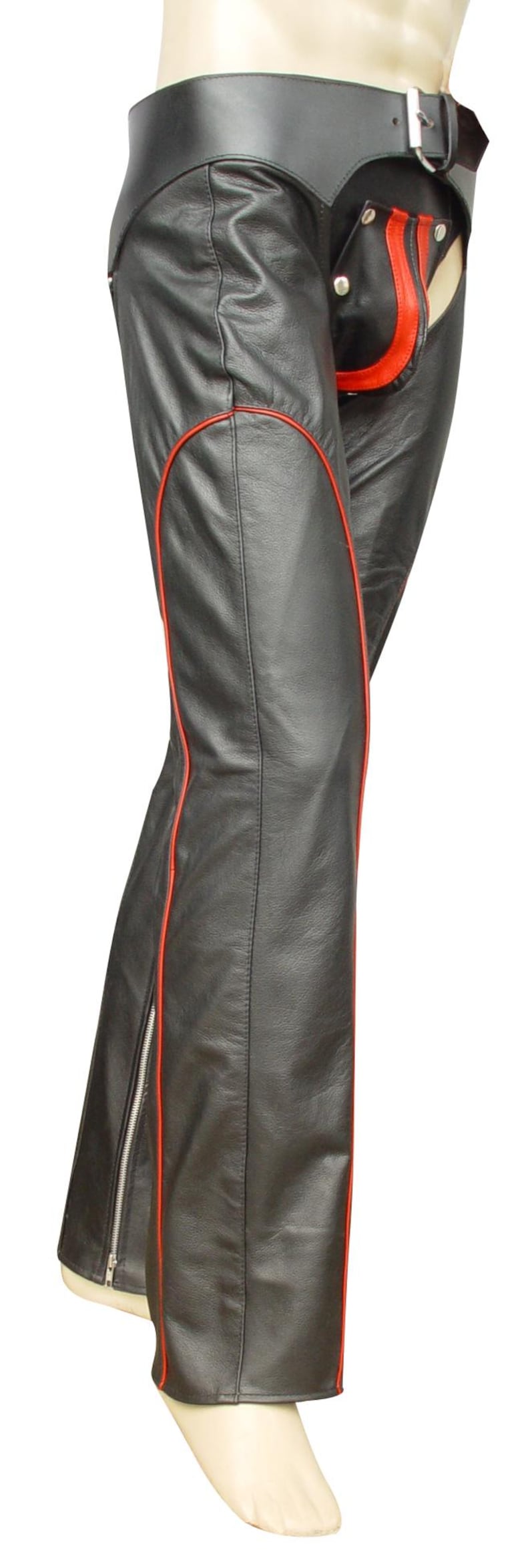 May include: Black leather chaps with red trim. The chaps have a wide waistband with a buckle closure and a red accent on the front. A zipper runs along the outer seam of the leg.